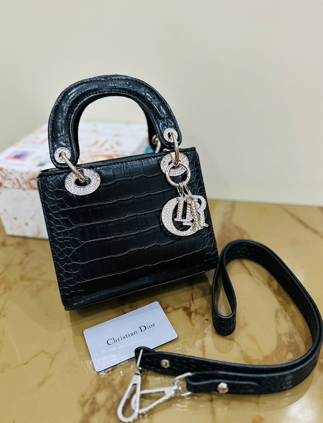Black Lady Dior style handbag featuring signature cannage stitching and Dior charm detailing