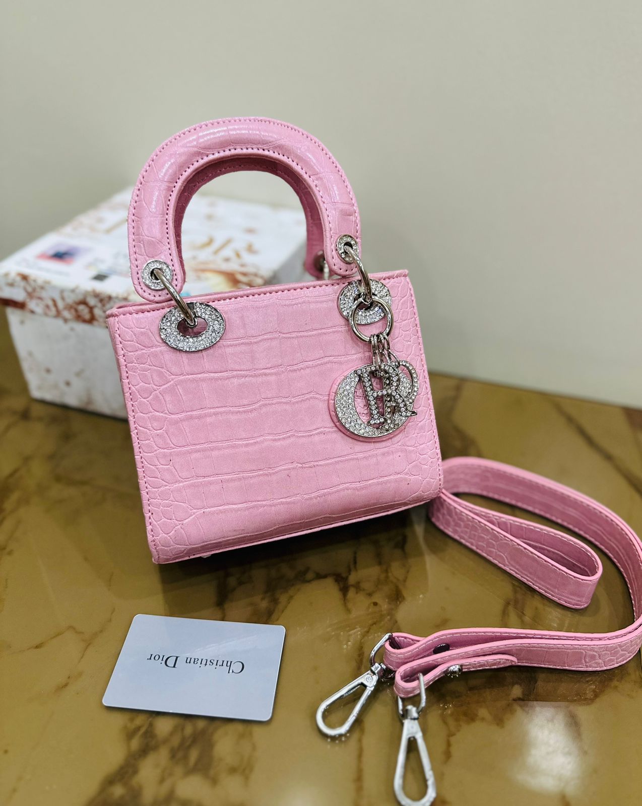 Pink Christian Dior handbag with quilted leather and gold hardware, perfect for elegant occasions