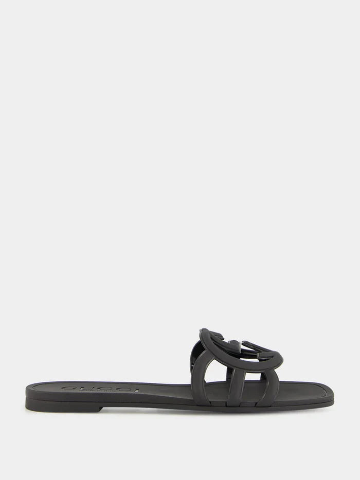 Close-up of black Gucci Mystic logo strap – elegant embossed branding on soft rubber women’s slide sandals.