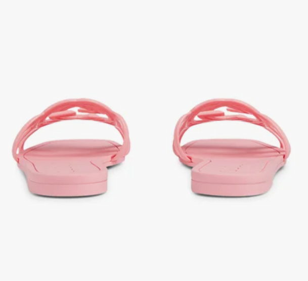 Gucci pink Mystic logo slides worn by model – fashionable and comfortable sandals for everyday summer outfits.